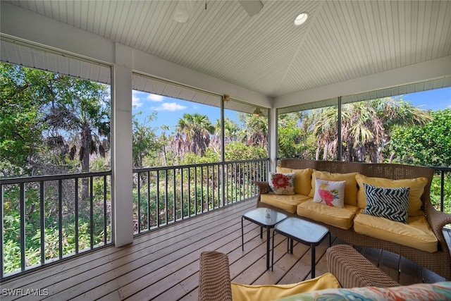 sunroom with plenty of natural light and lofted ceiling