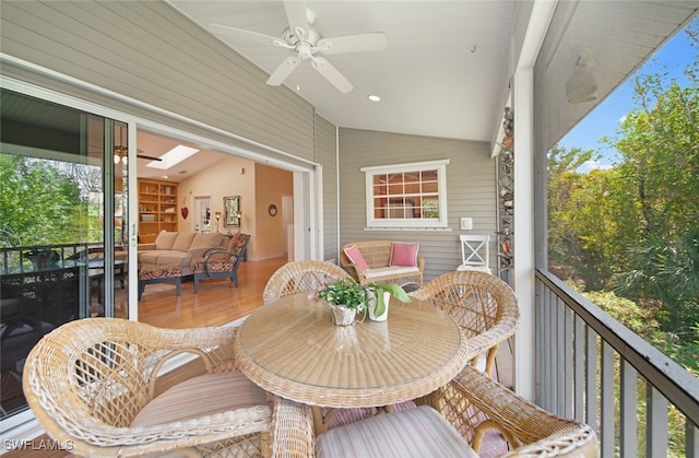 sunroom featuring ceiling fan and lofted ceiling with skylight