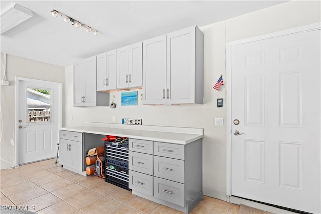 kitchen with gray cabinets and light tile patterned flooring