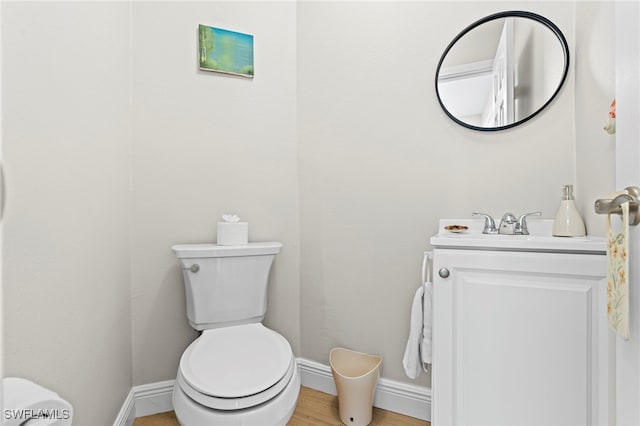 bathroom featuring hardwood / wood-style floors, vanity, and toilet