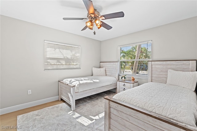 bedroom with light hardwood / wood-style flooring and ceiling fan