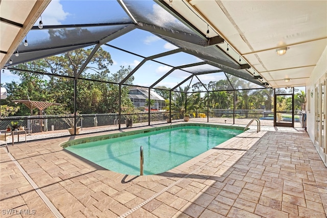 view of pool featuring a patio area and a lanai