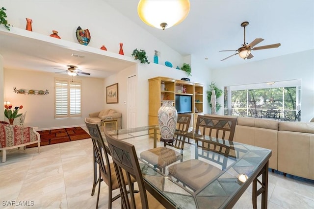 dining space featuring visible vents, ceiling fan, and vaulted ceiling