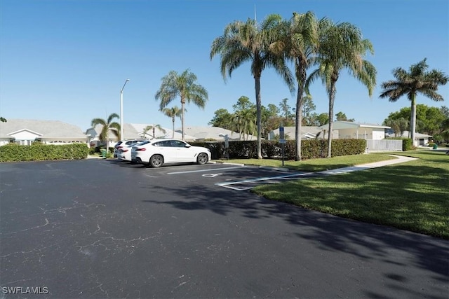 view of vehicle parking featuring a yard