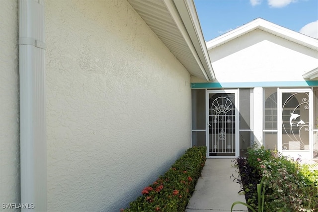 property entrance with stucco siding