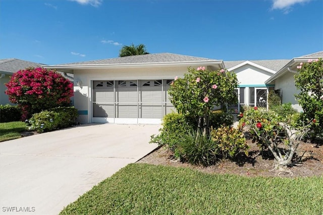 view of front of property featuring stucco siding, driveway, and an attached garage