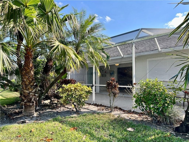 6292 Shadowood Cir Unit 1701, Naples, FL 34112 - view of home's exterior featuring a shingled roof and a lanai