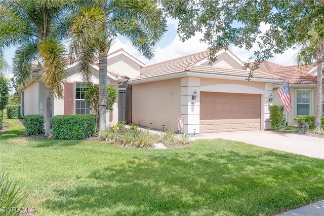 view of front facade with driveway, a tiled roof, an attached garage, a front lawn, and stucco siding