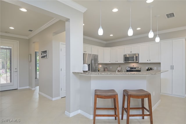 kitchen featuring white cabinets, stainless steel appliances, visible vents, and crown molding