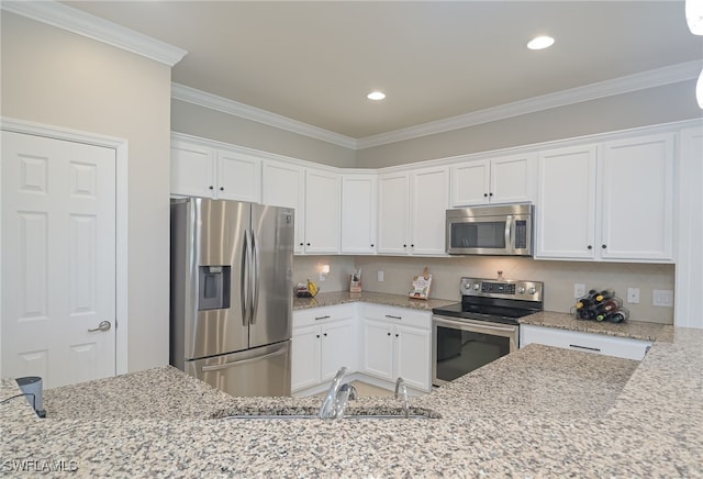 kitchen featuring crown molding, stainless steel appliances, light stone counters, and white cabinets