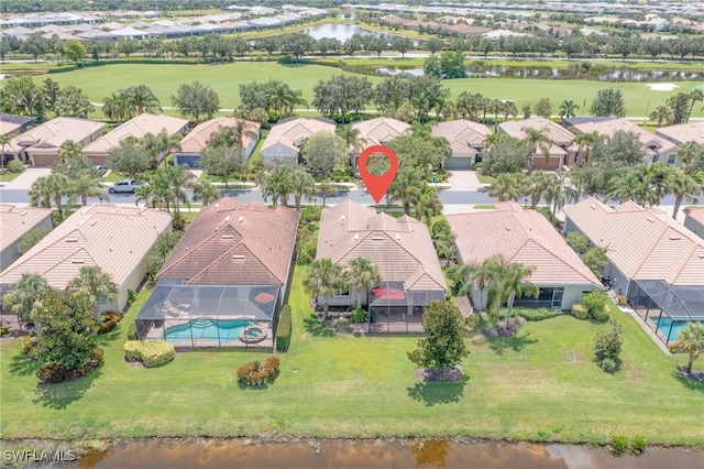 drone / aerial view featuring a water view, a residential view, and golf course view