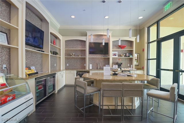 kitchen with tasteful backsplash, beverage cooler, white cabinets, light stone counters, and open shelves