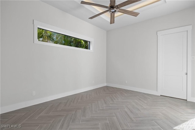 spare room with ceiling fan and parquet flooring