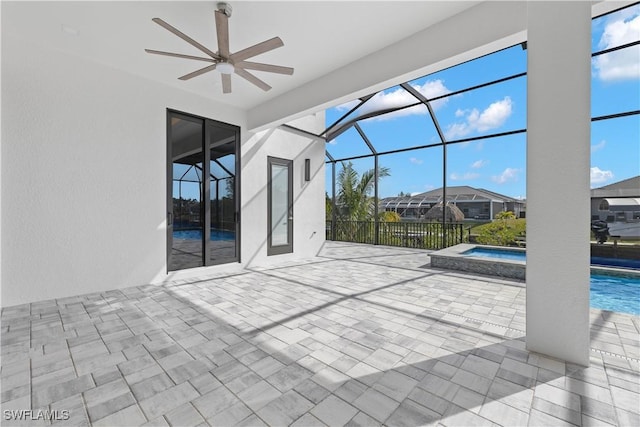 view of patio / terrace featuring ceiling fan, a pool with hot tub, and a lanai