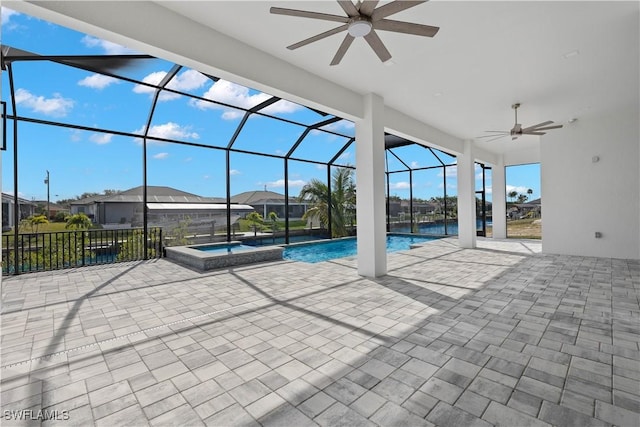 view of pool with an in ground hot tub, a patio area, ceiling fan, and a lanai