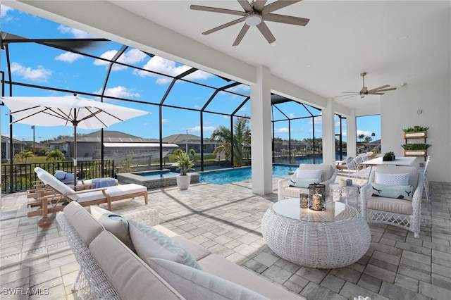 view of patio featuring ceiling fan, a swimming pool with hot tub, a lanai, and an outdoor hangout area