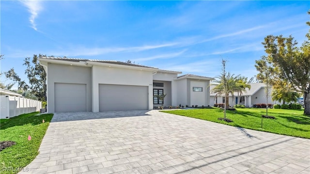 view of front facade featuring a garage and a front yard