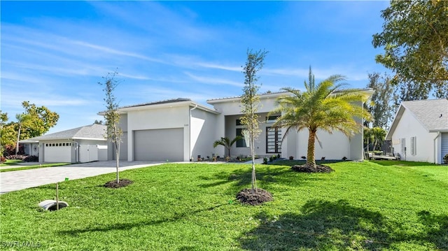 view of front facade with a garage and a front lawn