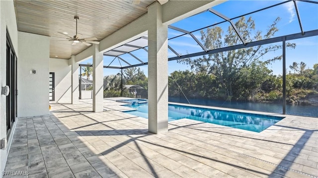 view of pool featuring a water view, ceiling fan, a lanai, and a patio area