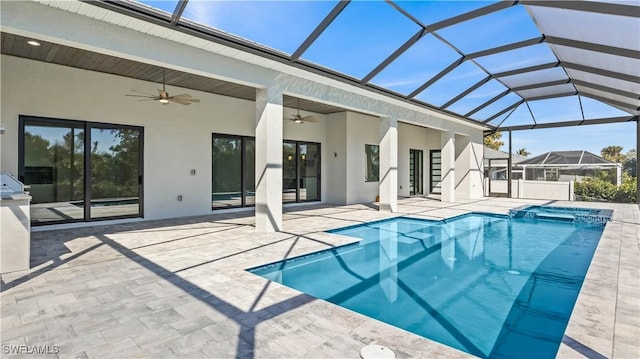 view of pool with ceiling fan, a lanai, and a patio