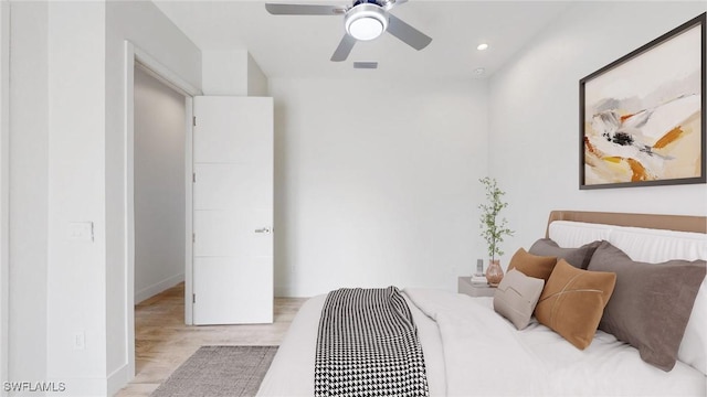 bedroom with ceiling fan and light hardwood / wood-style floors