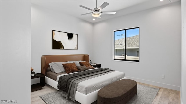 bedroom with ceiling fan and light hardwood / wood-style flooring