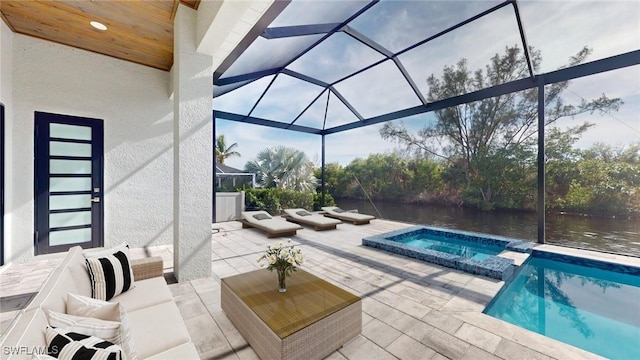 view of pool featuring a lanai, a patio area, an in ground hot tub, and a water view