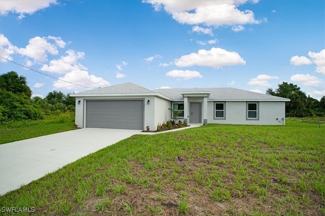 view of front of property featuring a front yard and a garage