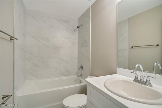 full bathroom featuring vanity, tiled shower / bath combo, and toilet