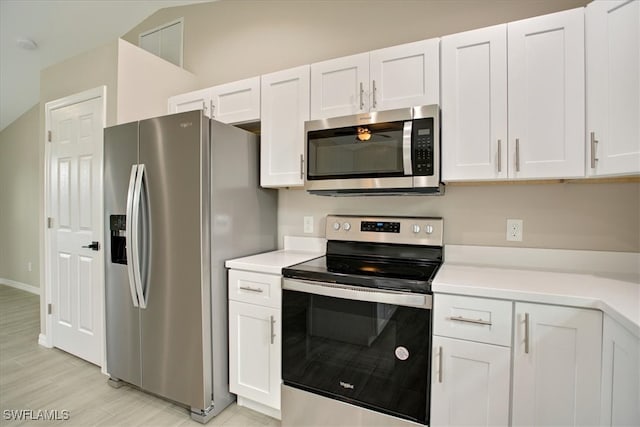 kitchen with white cabinets, light hardwood / wood-style floors, and appliances with stainless steel finishes