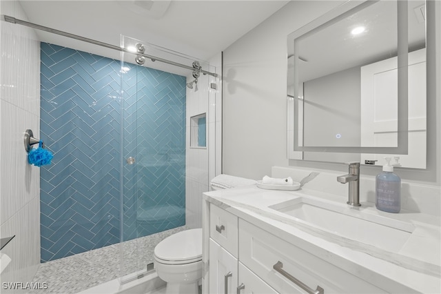 bathroom with vanity, toilet, and a tile shower