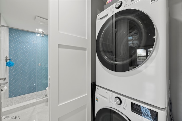 laundry area featuring stacked washing maching and dryer