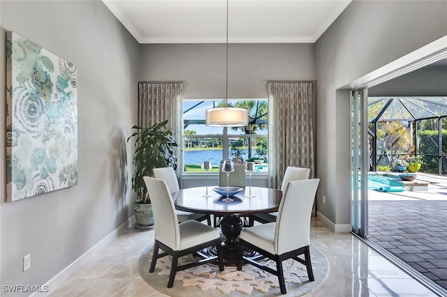 dining room featuring a water view and crown molding