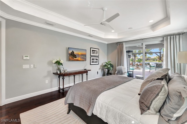 bedroom featuring access to outside, ceiling fan, ornamental molding, a tray ceiling, and dark hardwood / wood-style flooring