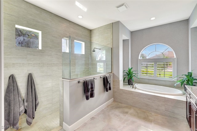 bathroom featuring plus walk in shower and vanity