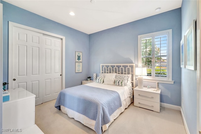 bedroom with light colored carpet and a closet