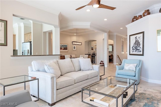 living room featuring ceiling fan with notable chandelier and ornamental molding