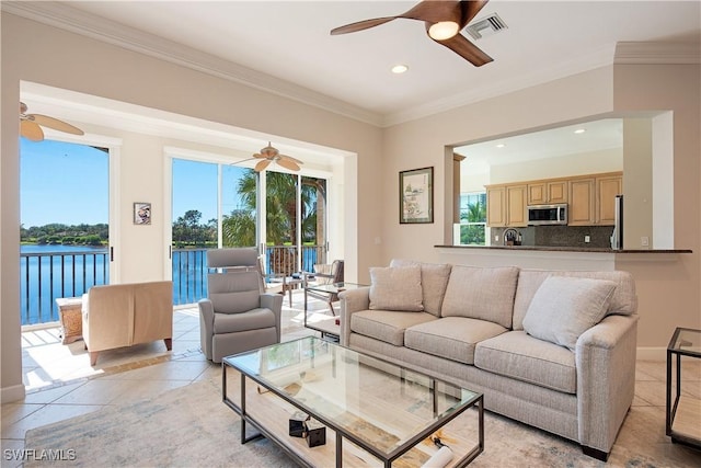 tiled living room featuring a water view and crown molding