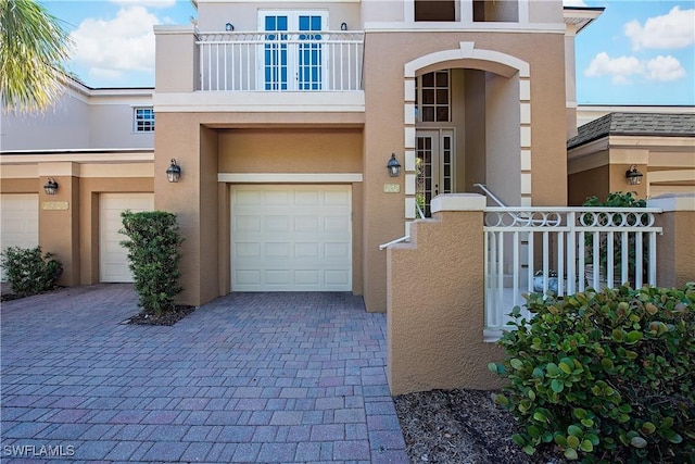 view of front of house featuring a balcony and a garage