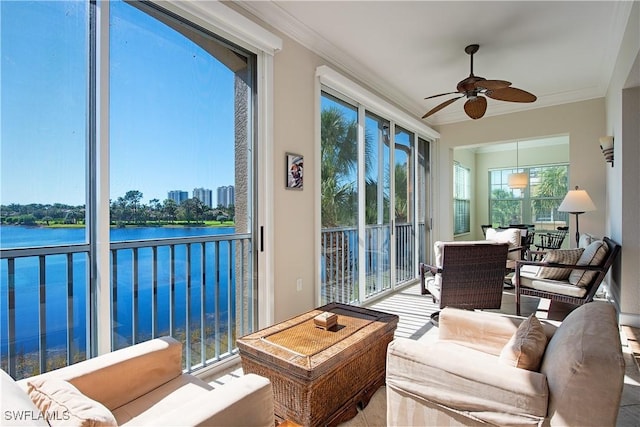 sunroom / solarium with a water view and ceiling fan