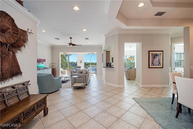 living room featuring ceiling fan, light tile patterned floors, and ornamental molding