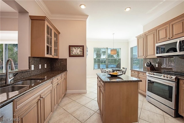 kitchen featuring appliances with stainless steel finishes, tasteful backsplash, dark stone counters, sink, and hanging light fixtures