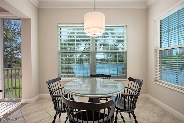 tiled dining room featuring a wealth of natural light and ornamental molding