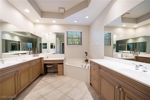 bathroom featuring tile patterned flooring, vanity, a raised ceiling, and shower with separate bathtub