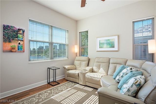 living room featuring wood-type flooring, plenty of natural light, and ceiling fan