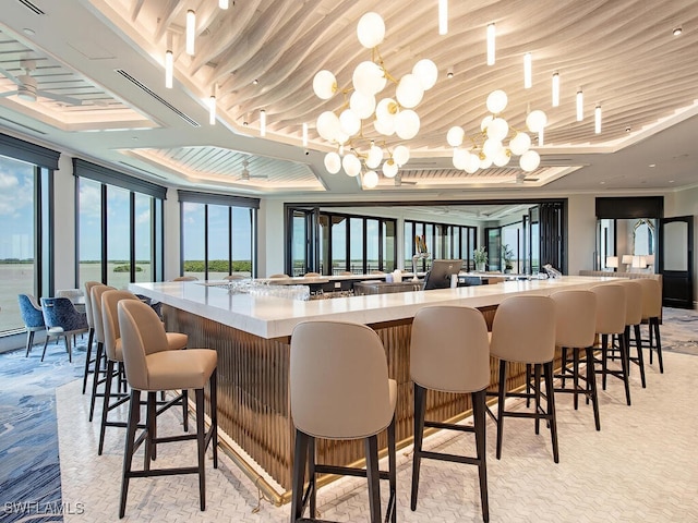 bar featuring a wealth of natural light and an inviting chandelier