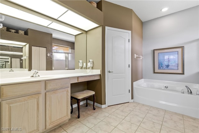 bathroom with vanity, tile patterned floors, and a tub