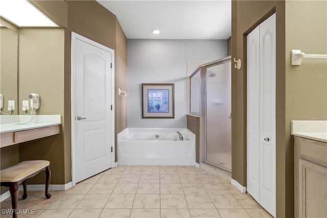 bathroom featuring tile patterned floors, vanity, and shower with separate bathtub