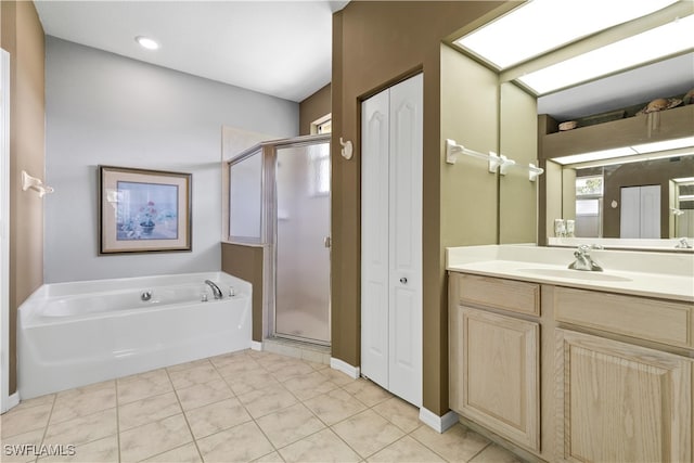 bathroom with tile patterned floors, vanity, and independent shower and bath