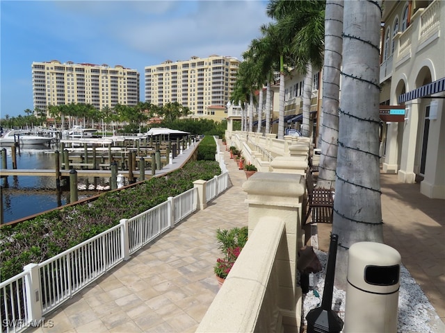 view of property's community featuring a water view and a dock